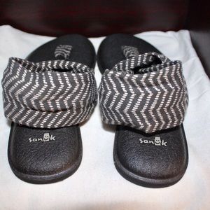 Black wrap around sanuk sandals, size 7